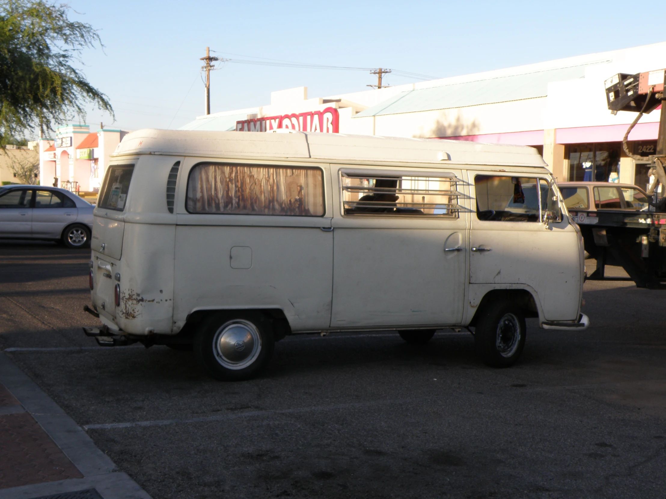 an old, vintage white van is parked on the street