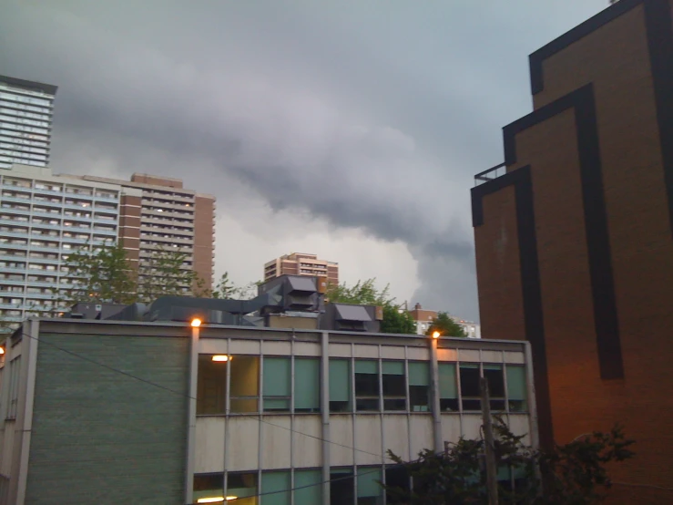 a storm rolls through the city on a cloudy day