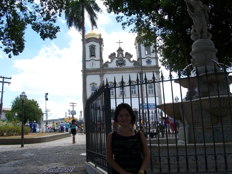 an image of a woman standing in front of a gate