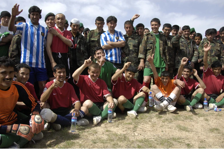 a group of boys in uniforms pose for a po