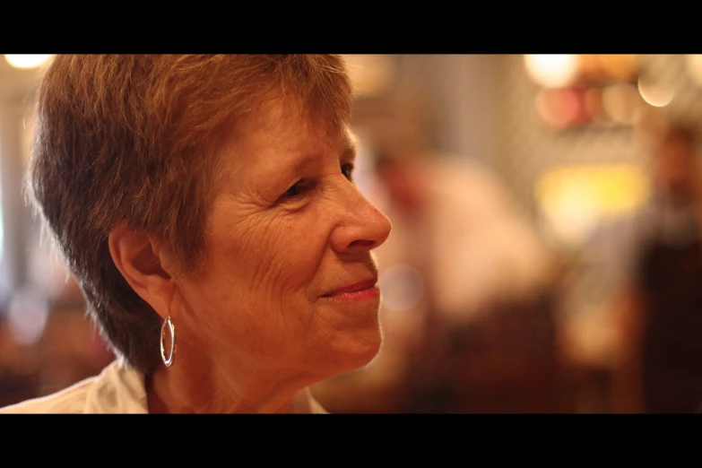 an older woman with a pair of earrings on her face