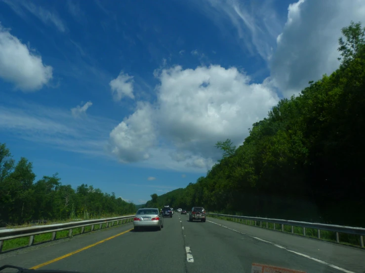 a group of cars driving down the highway