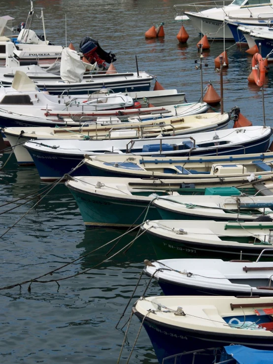 a bunch of small boats floating around in the water