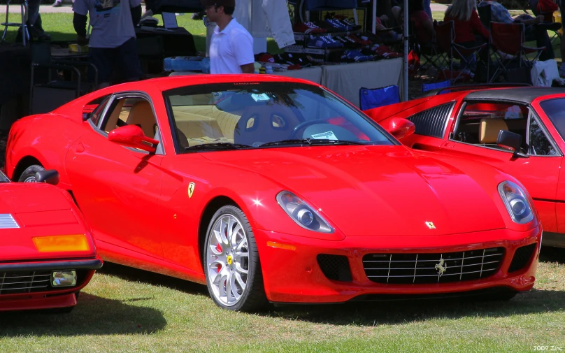 there are two red ferraris that are on display