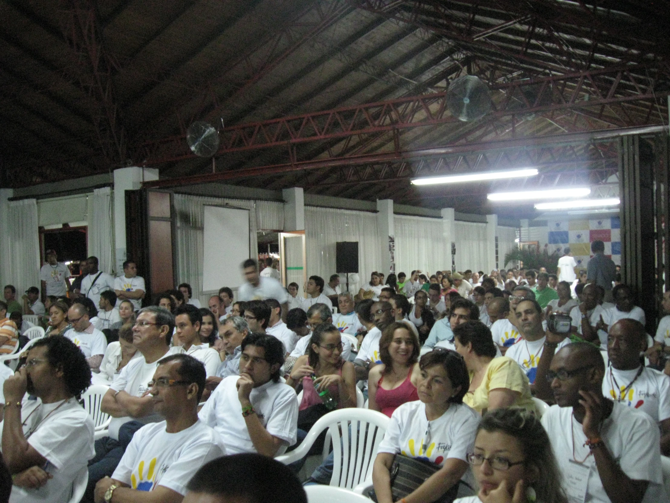 the large crowd of people at the convention is sitting