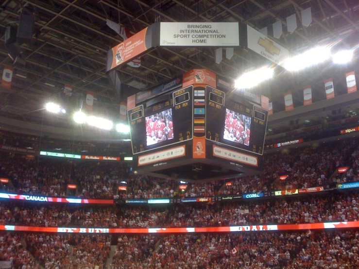 an empty basketball court with two banners on the ceiling