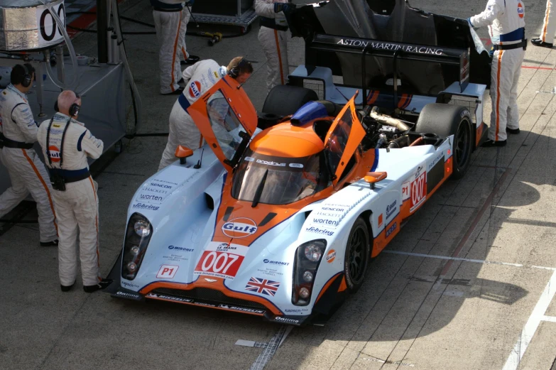 a race car with its door open in an open space