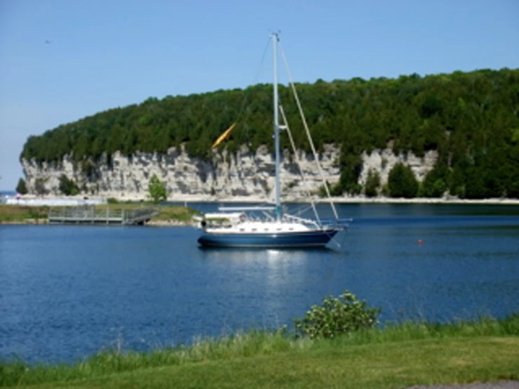 there is a sail boat that is out on the lake