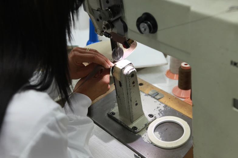 woman with long black hair on the machine working