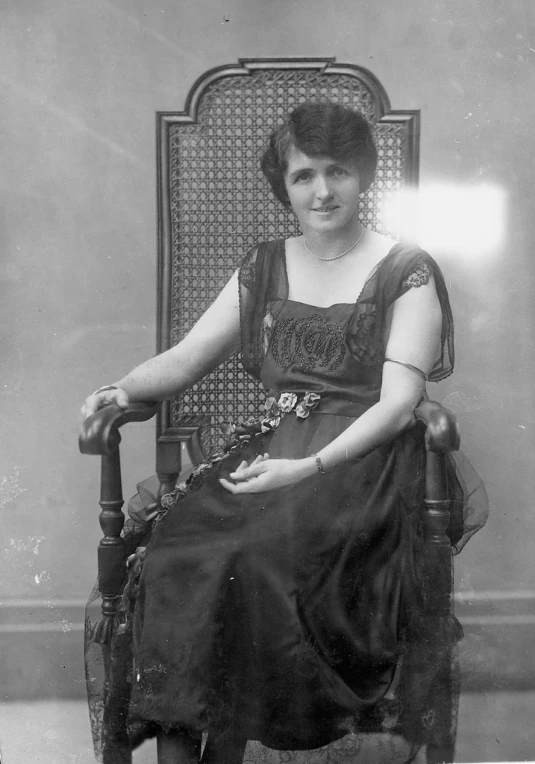 a black and white po of a woman in a chair