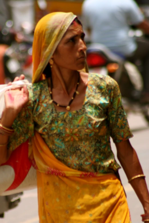 an older woman is carrying bags and a purse