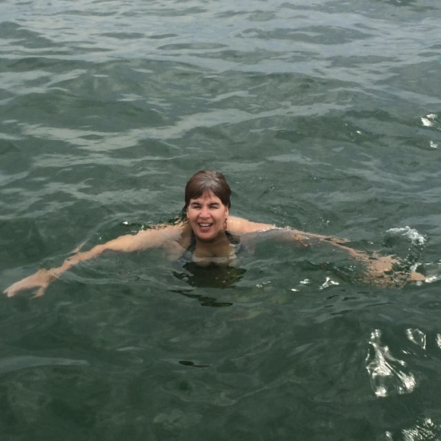 an image of a man swimming in the water