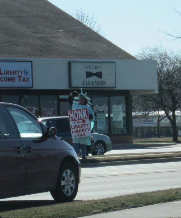 a man in white suit standing on the sidewalk