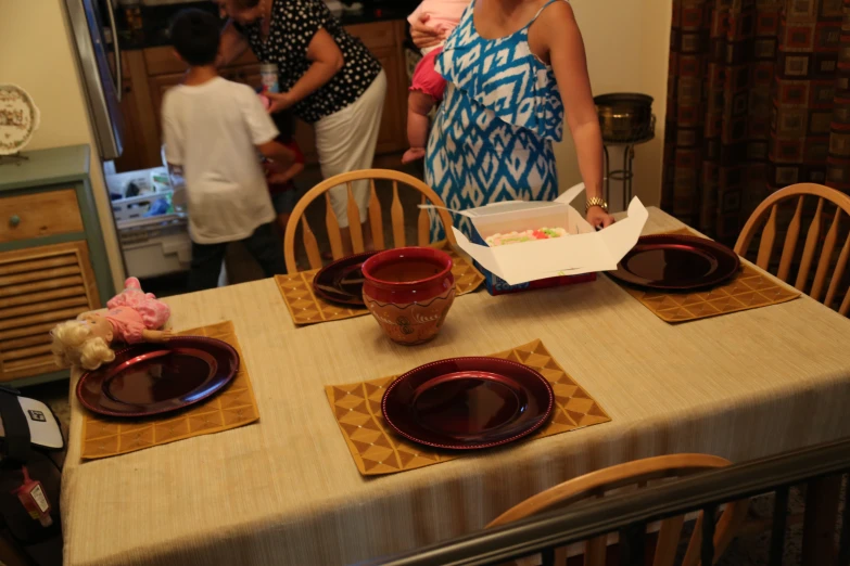 a woman preparing for a family celetion in a dinning room