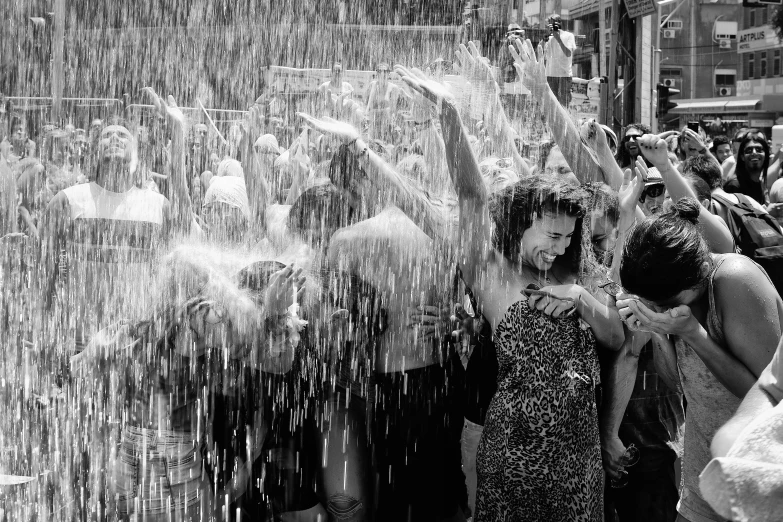 several people standing behind a group of water jets