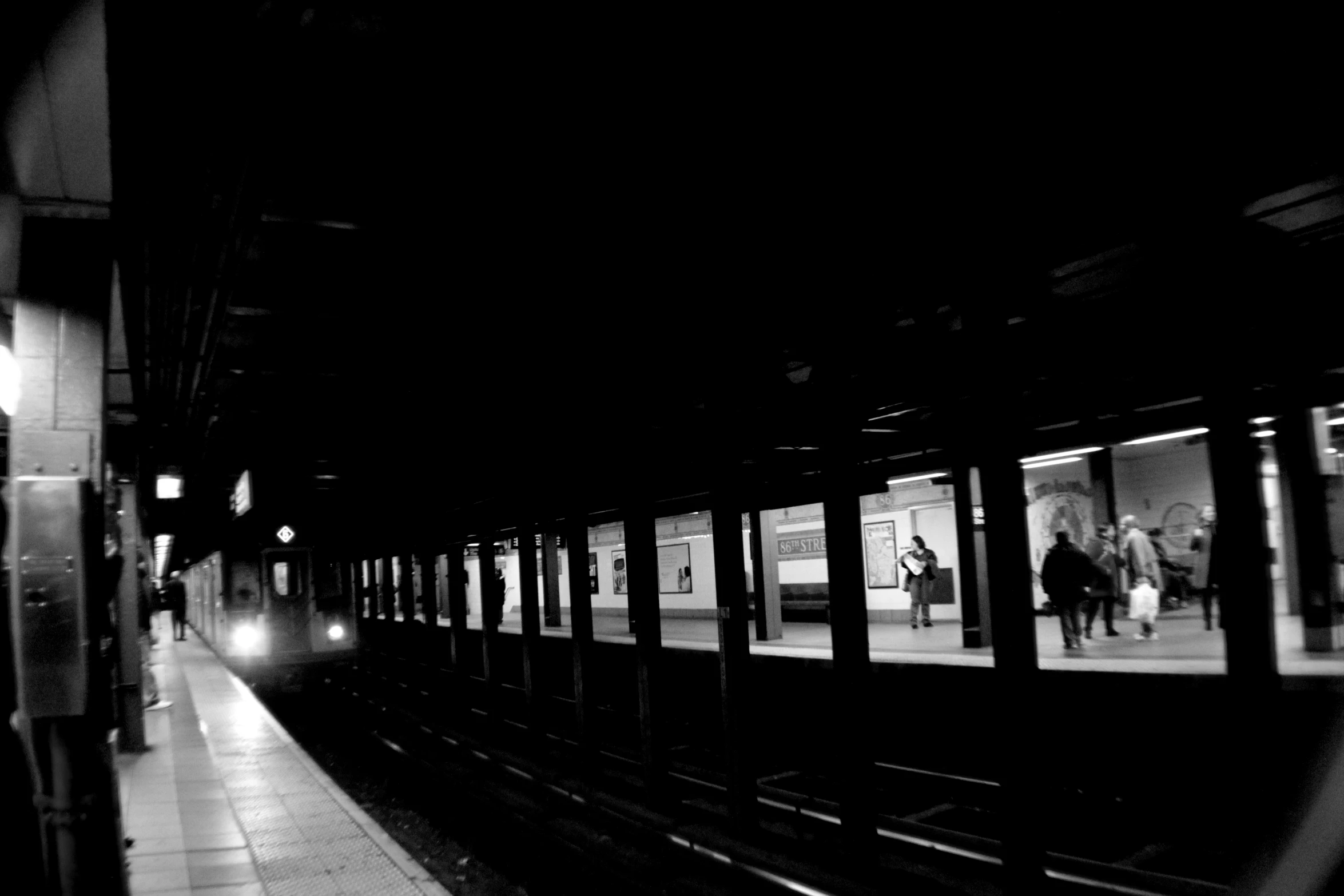 people waiting on a train in a crowded station