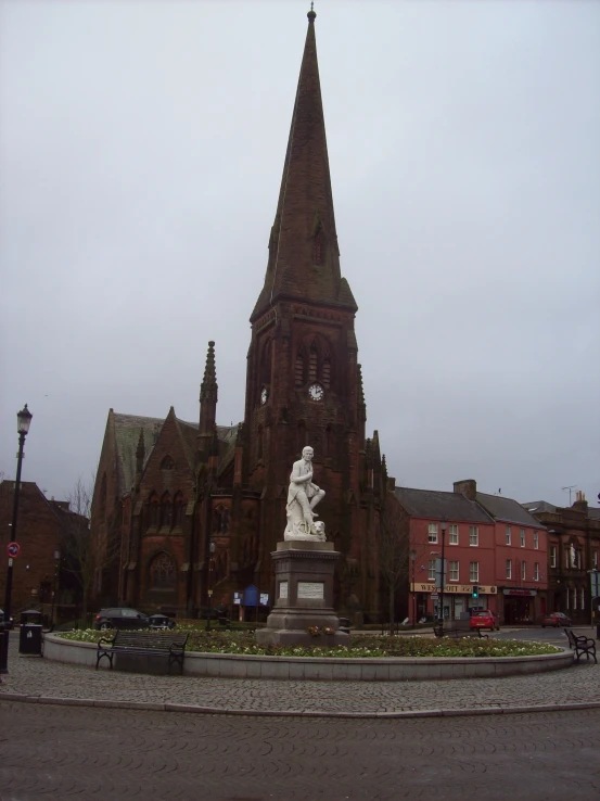 a big cathedral with a large stone statue in front