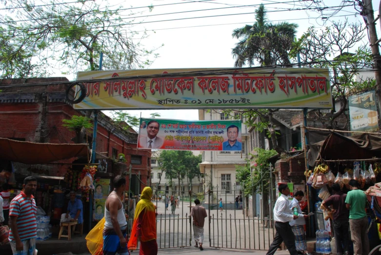 an entrance to a market with people walking through it