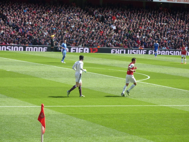 a group of men playing a game of soccer on a field