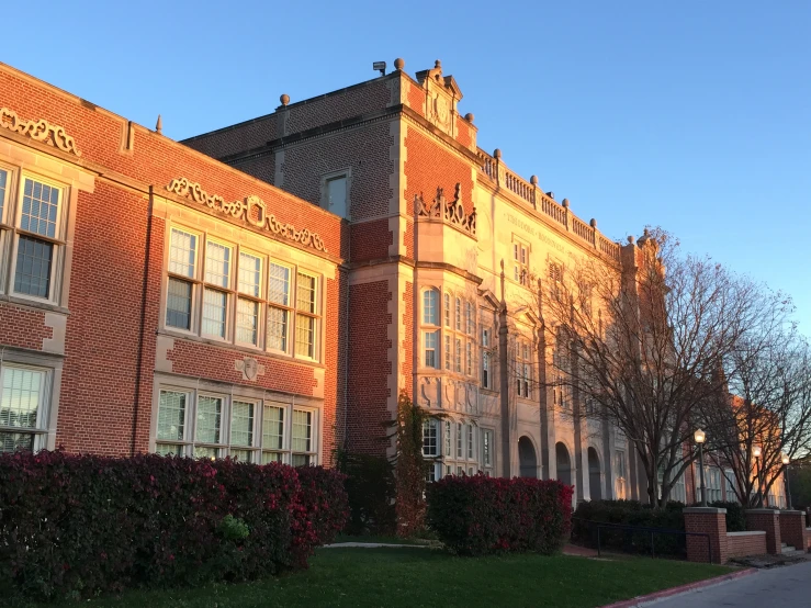 a brick building is shown in a sunset image