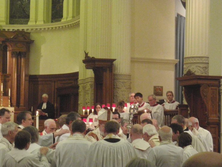 a large group of people in a church with candles