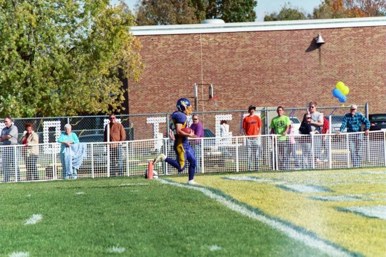 a man with a ball running in a field