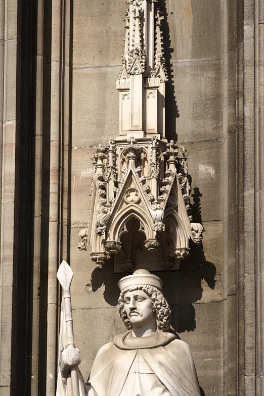 an old statue of a man and a woman with a clock