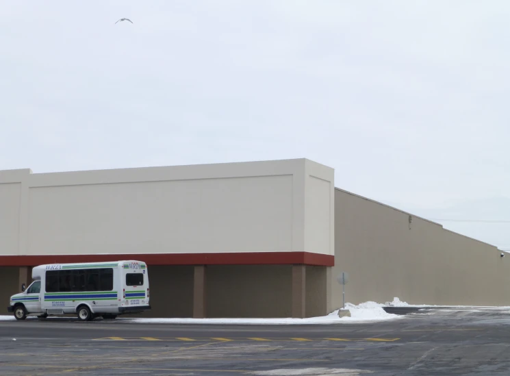 an rv parked in front of a building in winter