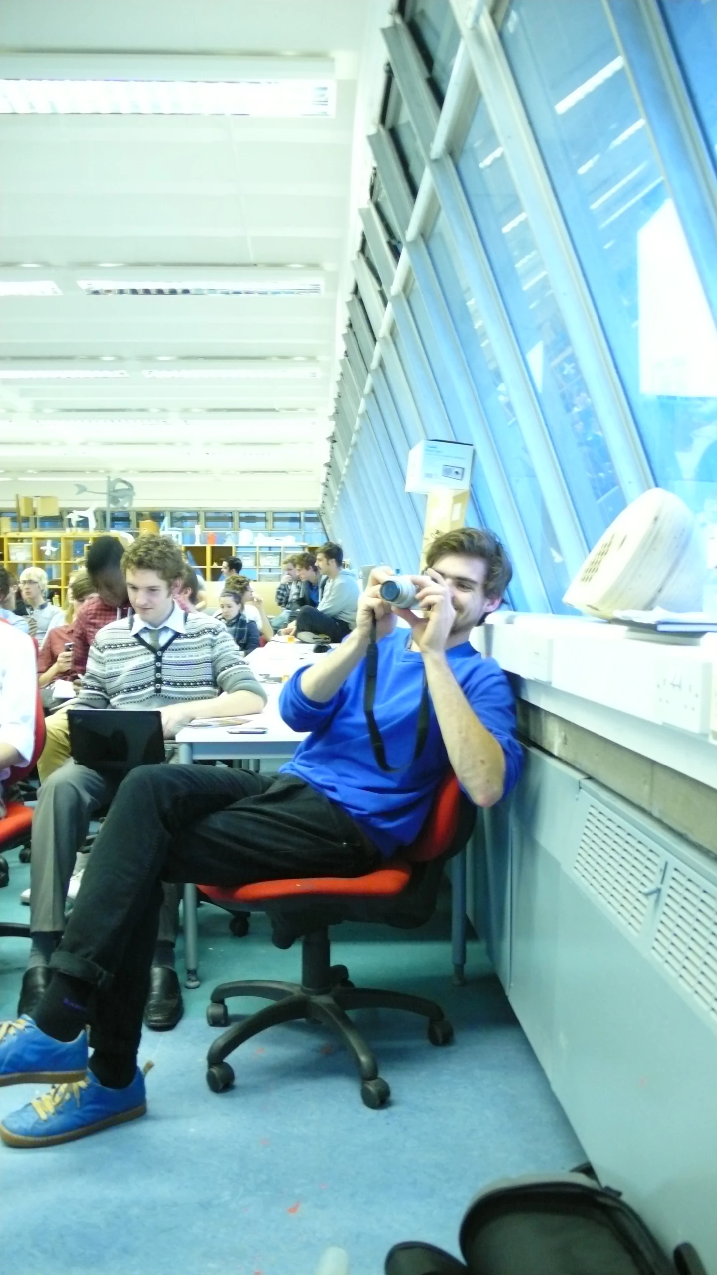 a man sits in an office chair at a desk