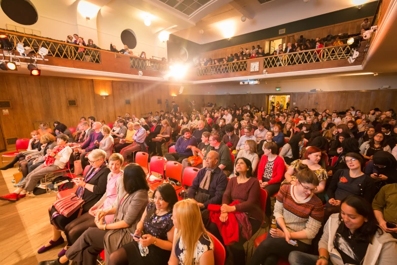 a large group of people sitting and standing