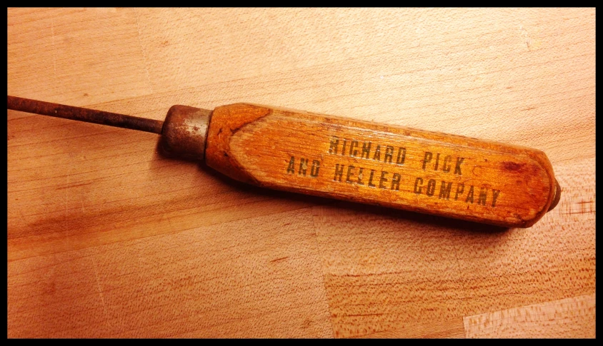 an old wooden piece with an old wood handle