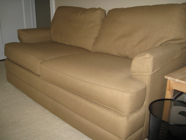 a brown couch that is in a room