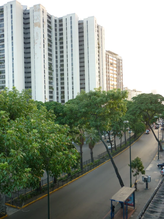 there are several tall buildings along the side of this road