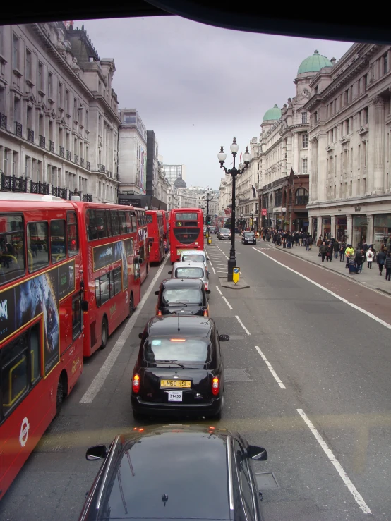 a view down a busy city street filled with buses