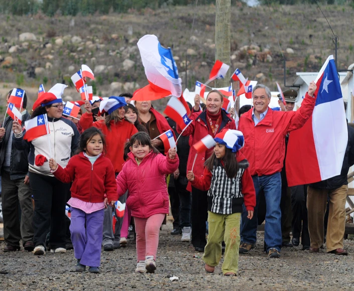 a large group of people holding flags and waving