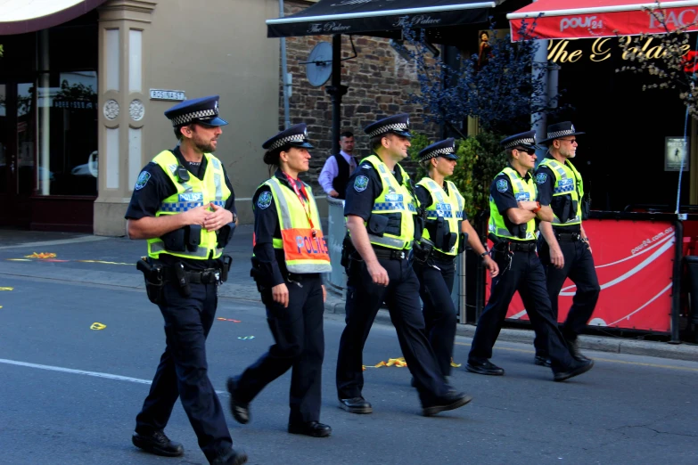 some police officers are walking on the street