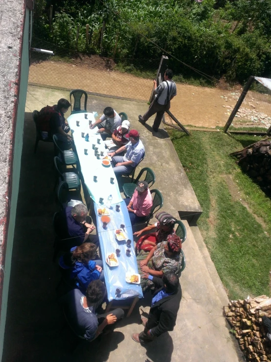people sit around a long table for a picnic