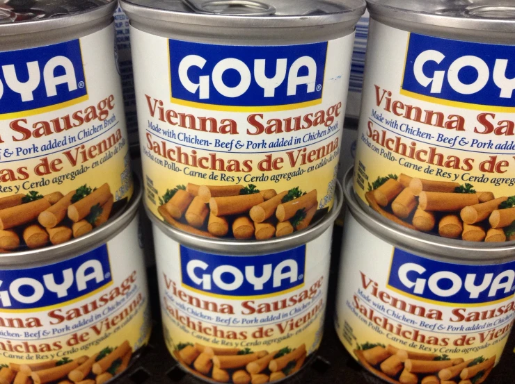 several cans of goya canned food sit on the shelf