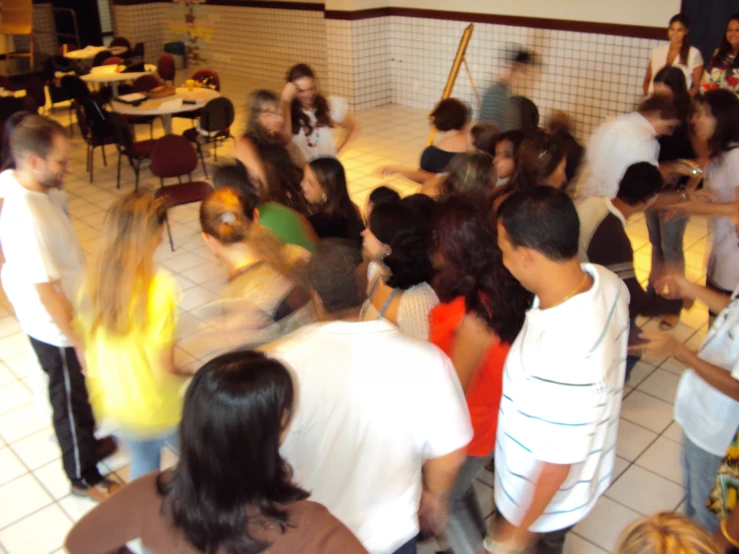 a group of people standing around each other on a floor