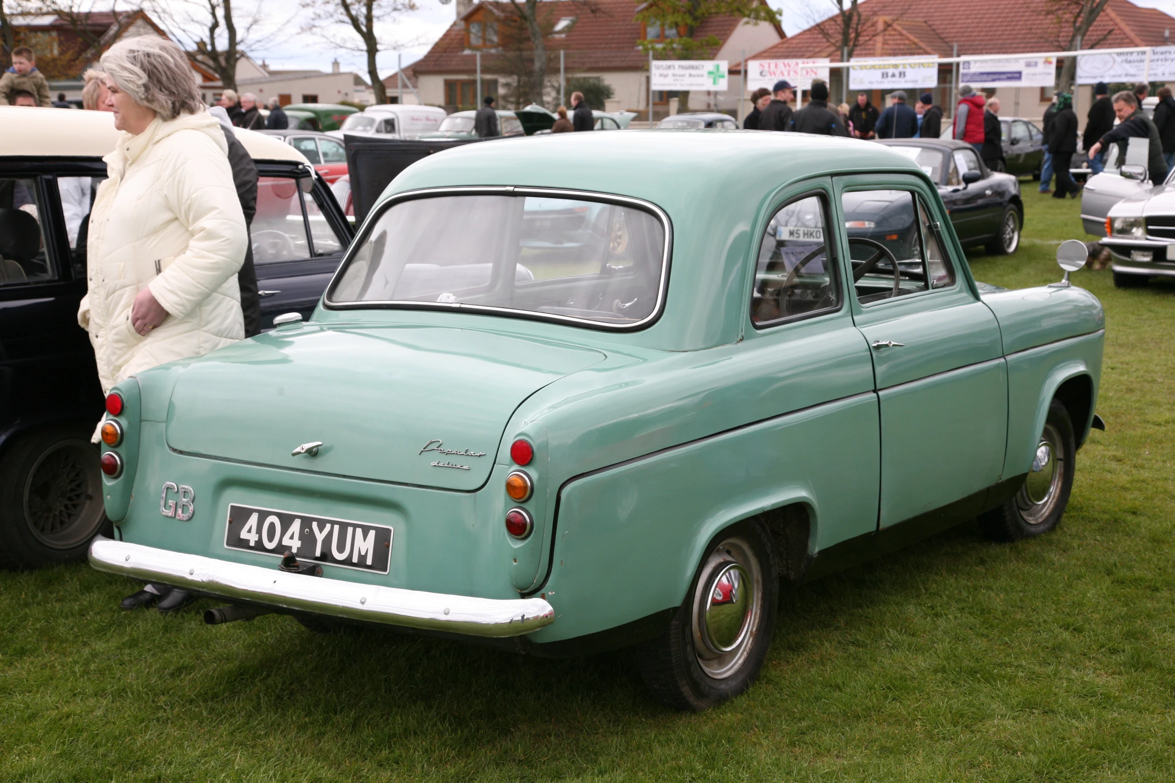 two old fashion cars on display at an event