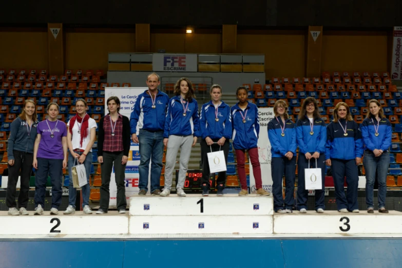 a group of people standing on a winners podium