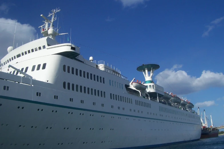 a large white cruise ship docked at a pier