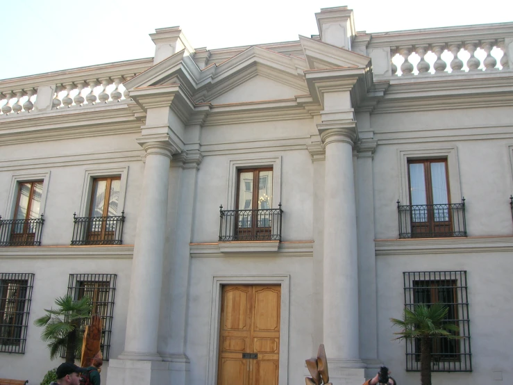 a white building with many windows and a gate