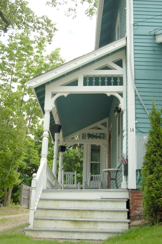 an outside view of a blue and white house