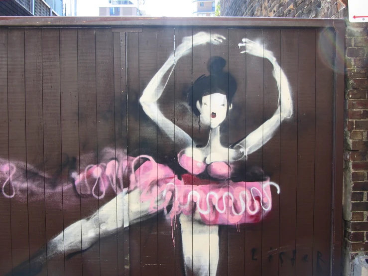 an image of a woman painted on a fence