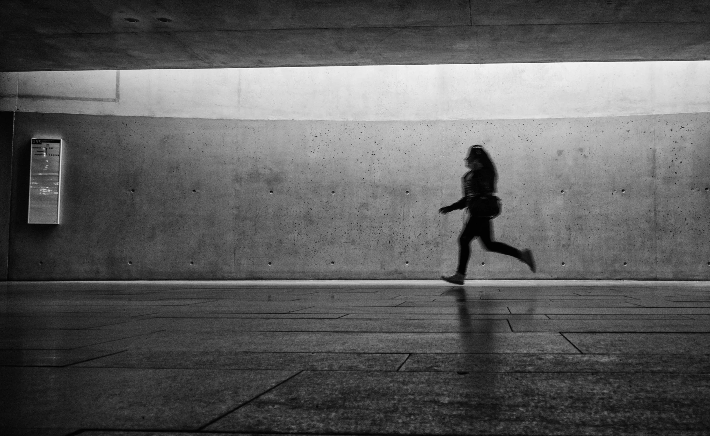 silhouette pograph of a person on an empty city street