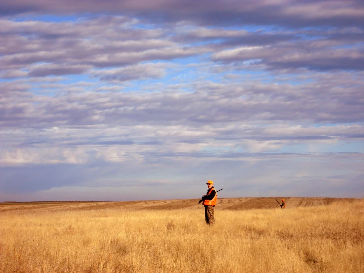 a man walking across a lush grass covered field