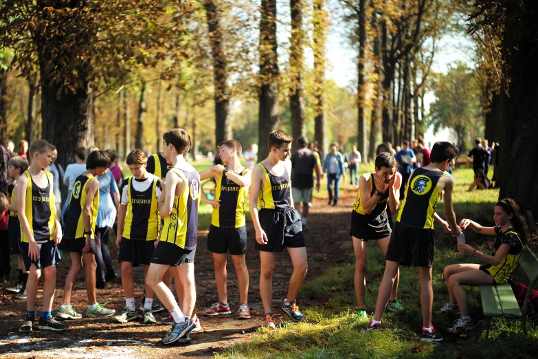 a group of young people standing next to each other in a forest