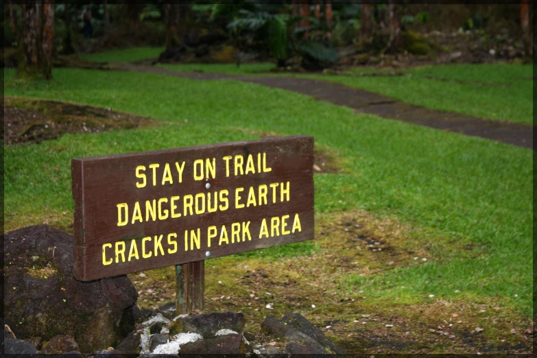 a sign with words describing that you can't stay on trail dangerous earth s in park area