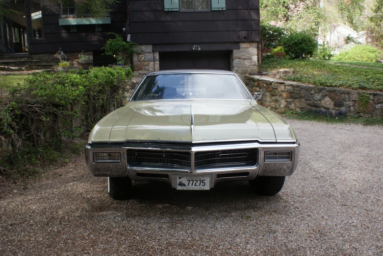 an older fashioned car parked in front of a house